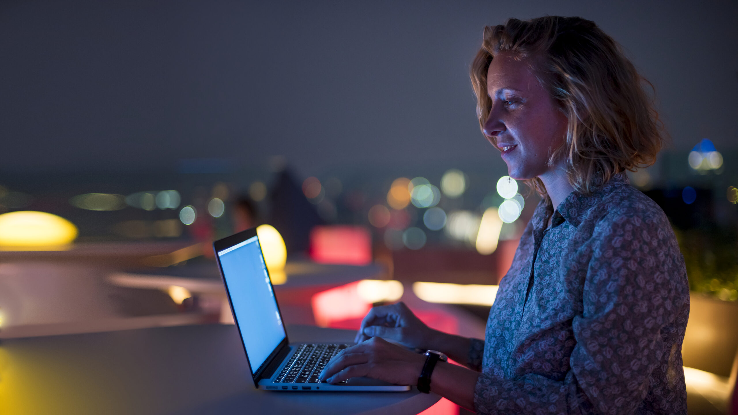 Woman using a laptop in the dark